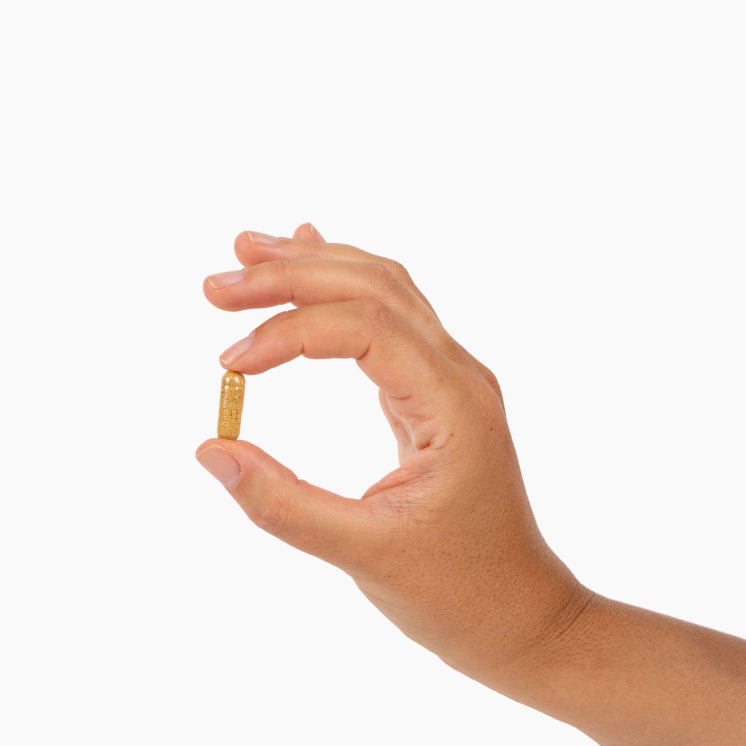 Hand holding one Preverio Glucose Metabolism Support capsule upright to show its small size