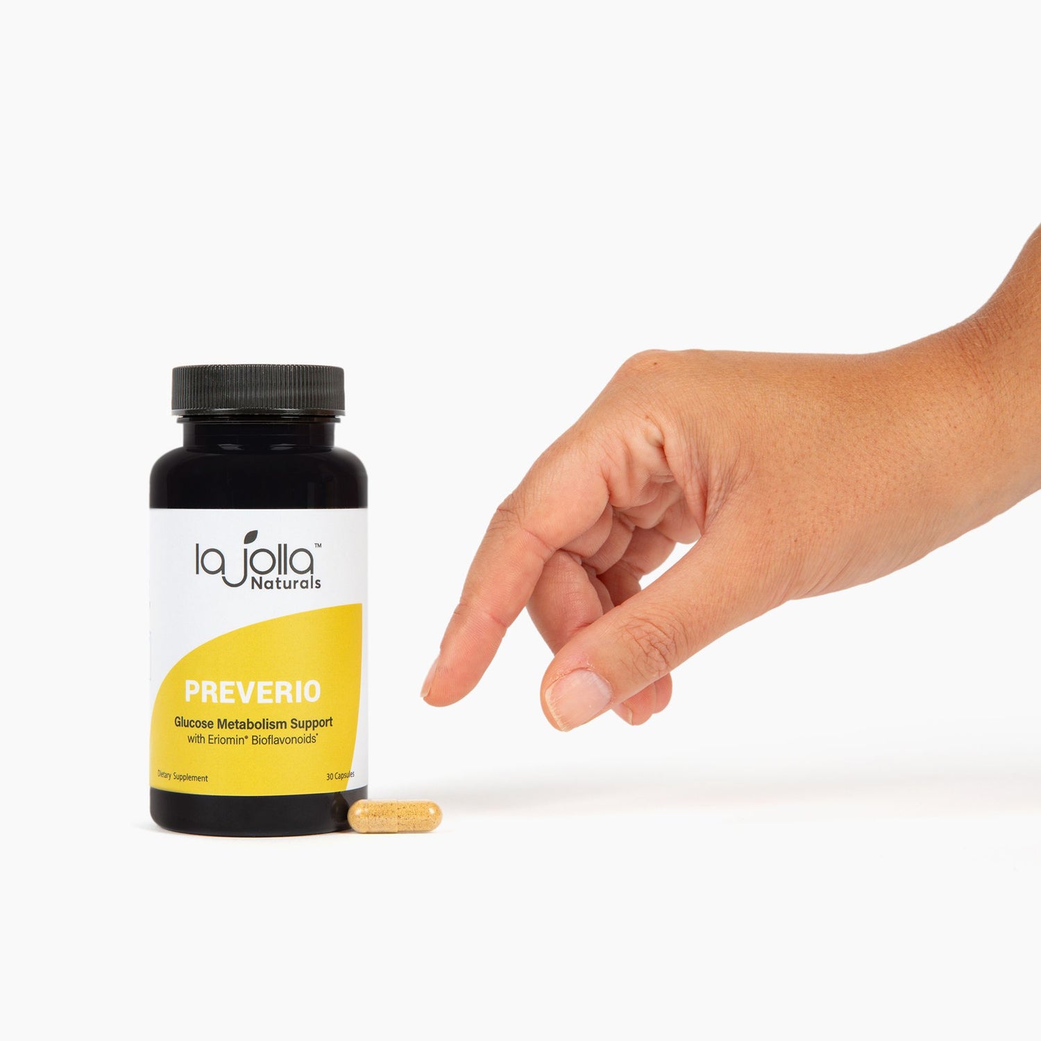 Bottle of Preverio Glucose Metabolism Support with a hand coming in from the right to pick up a capsule next to the bottle